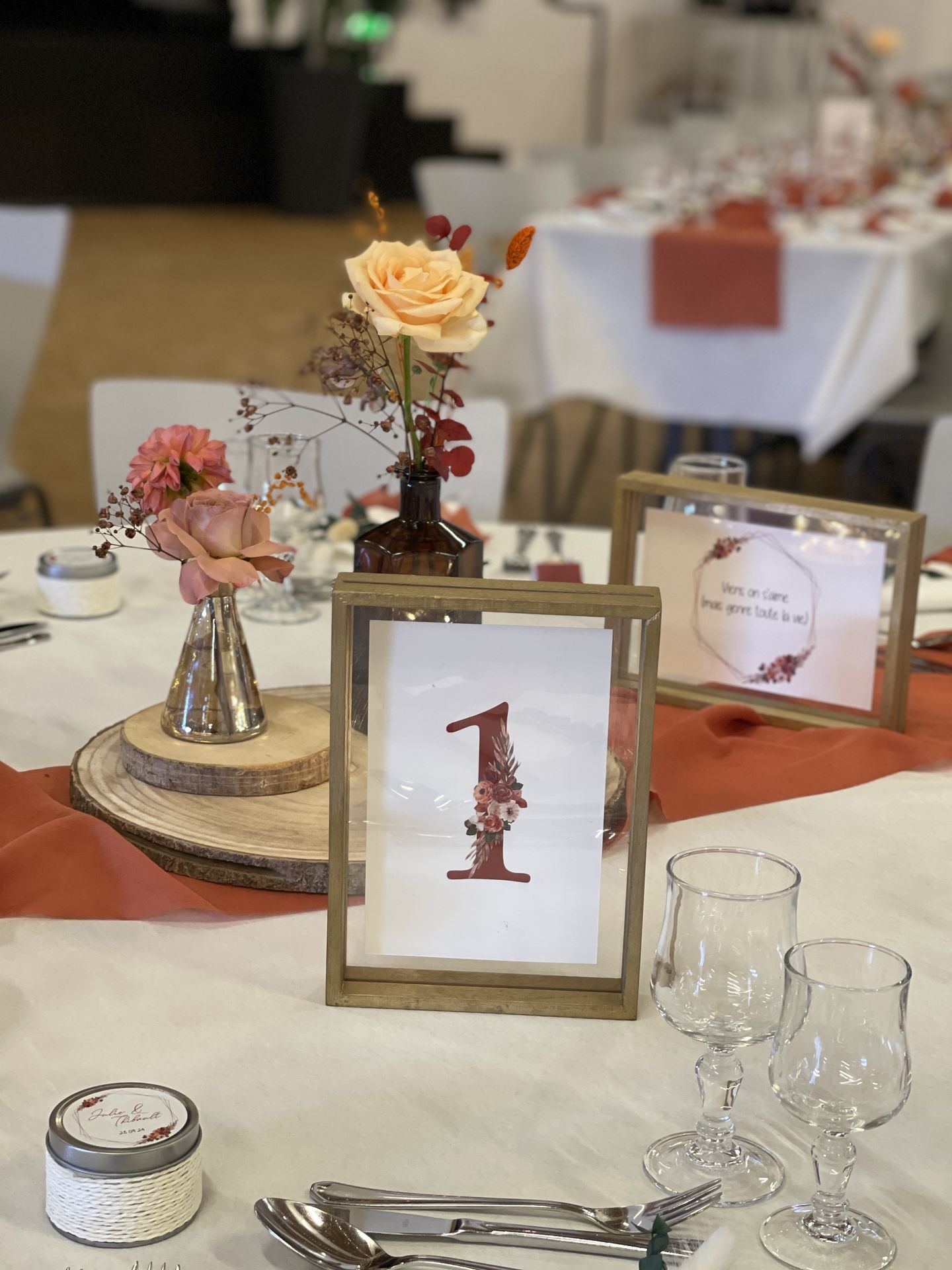 Mariage La Prairie table blanche cadre menu terracotta en bois rondin en bois vase fleuris et leds